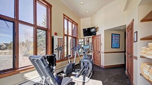 A gym with exercise equipment, large windows, and a television. - 2301 Red Hawk Lodge 2 Bedroom Condo (Keystone)