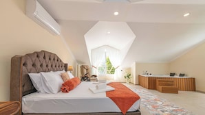 A spacious bedroom with a large bed, a small desk, and a view of the outdoors. - Close to Oludeniz 5 Bedroom Villa (Fethiye)