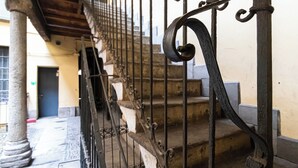 A staircase with ornate metal railings and stone steps.