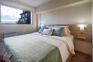 Enjoy a restful stay in this stylish room featuring a large bed, window with city views, and convenient amenities.
