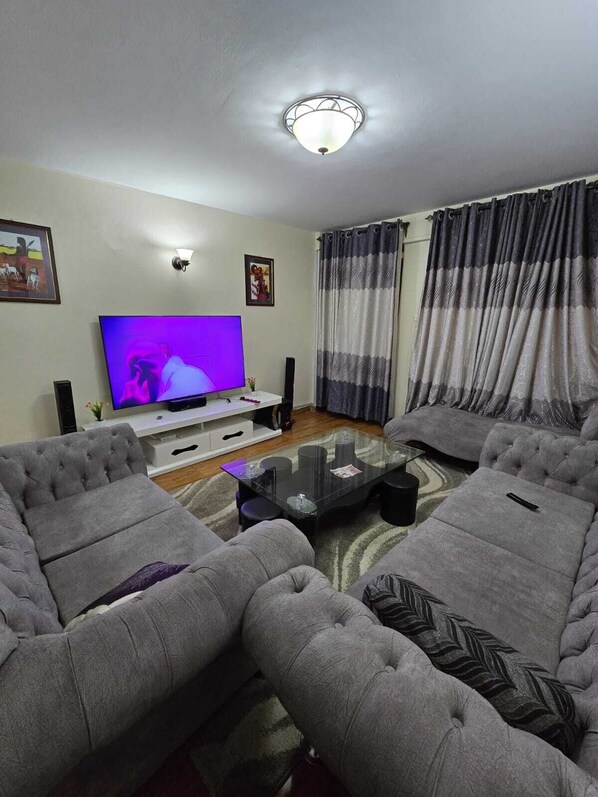 Family Apartment, City View | Living area | 24-inch Smart TV with digital channels - Lux Suites Astrol Apartments Garden City (Nairobi)