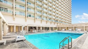 A hotel pool area with a clear blue pool, lounge chairs, and a lifeguard stand. - Ocean Views + Walkway to Mall-Ala Moana Hotel 2513 (Honolulu)