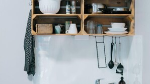 A compact kitchen with a coffee maker, kettle, and various utensils on shelves. - Mountain View Salzburg - SELF CHECK-IN - Apartments (Groedig)