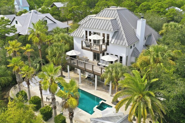 A multi-story house with a pool, surrounded by palm trees and other greenery. - Close to Beach, 2 Kitchens, Private Pool, Hot Tub (Santa Rosa Beach)