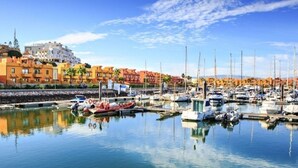 A marina with boats docked, a waterfront promenade, and buildings in the background. - Linaria Apartment, Portimão, Algarve (Portimão)