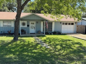 A single-story house with a front porch, a mailbox, and a mailbox slot.