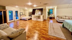 A spacious living area with a bunk bed, a sofa, and a chair. - Gorgeous Lakeside BarnHOUSE + SAUNA! (Ashland)
