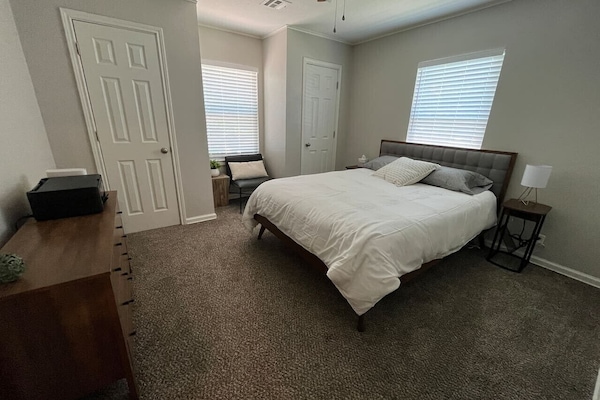 Queen-sized bed, room-darkening curtains, and a printer if needed