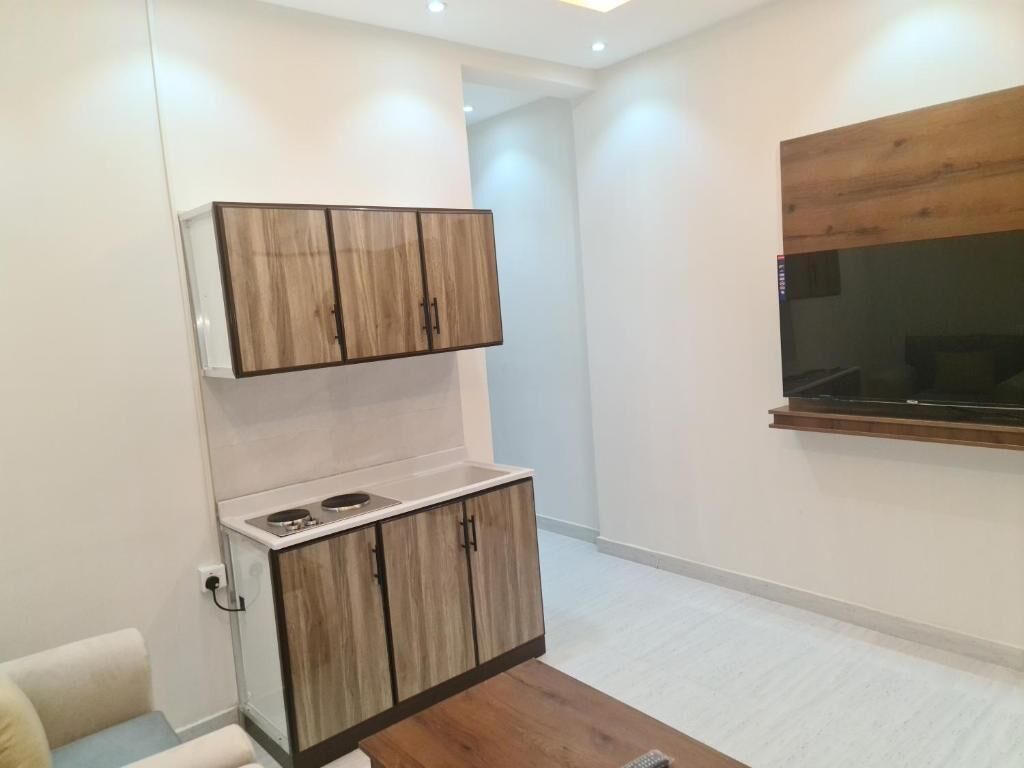 Deluxe Suite, 2 Bedrooms, Balcony, City View | Living area | TV, printers