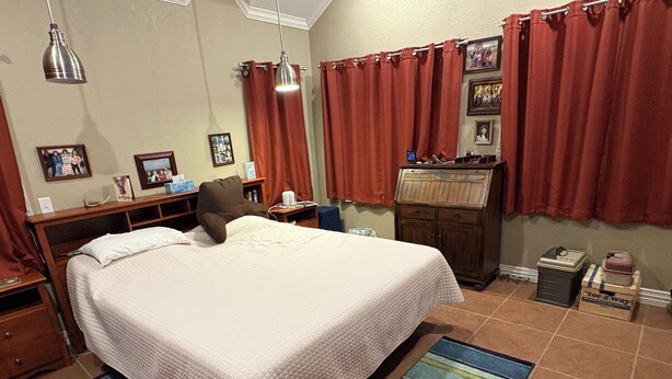 A bedroom with a large bed, a nightstand, a dresser, and a desk with a computer. - Captain's Cabin on Lake Godstone (Graford)