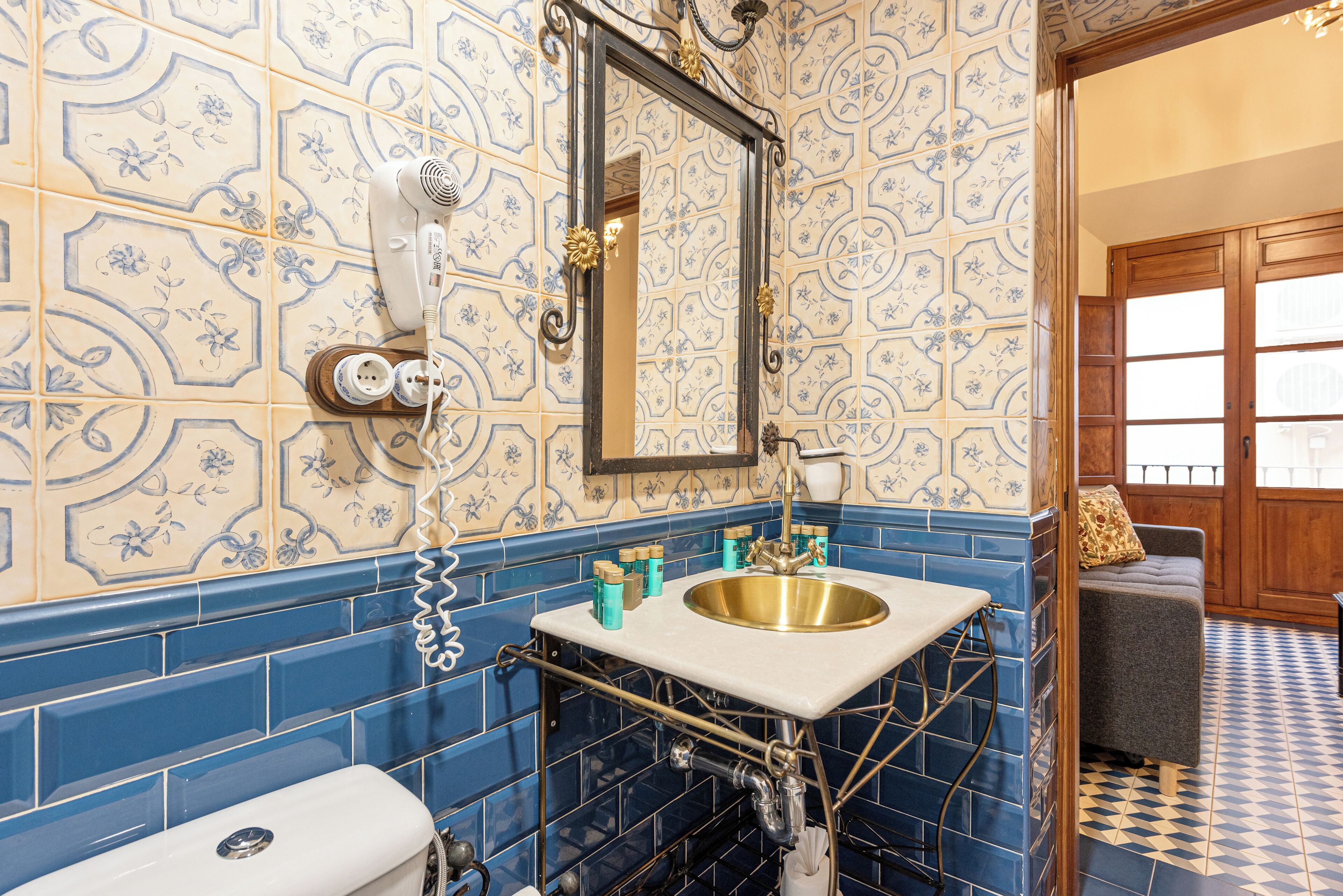 A bathroom with a sink, mirror, and toilet.