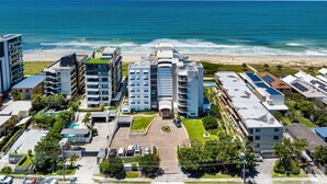 A coastal hotel with multiple buildings, a central courtyard, and a beach view. - Surf Watch Palm Beach (Palm Beach)