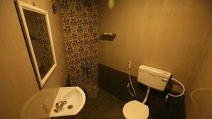 A bathroom with a sink, toilet, and mirror. - Le Apex Guest House (Vanur)
