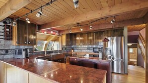 A modern kitchen with wooden cabinets, granite countertops, and stainless steel appliances. - Discover your perfect getaway in this spacious 3-bedroom home in Cortez, CO!  (Cortez)