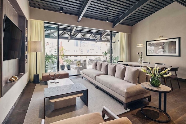 The Penthouse | Living area | 30-inch Smart TV with cable channels