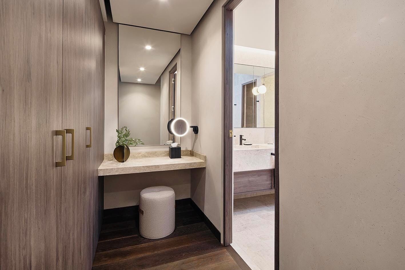 A modern bathroom with a vanity, a mirror, and a toilet.