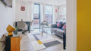 Un salon moderne avec un canapé, une table à manger et un téléviseur.