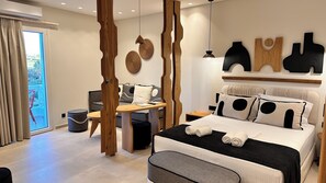 A modern bedroom with a bed, bedside tables, a desk, and a view through a sliding door. - Aristotle Suites, Avgi (Adamantas)