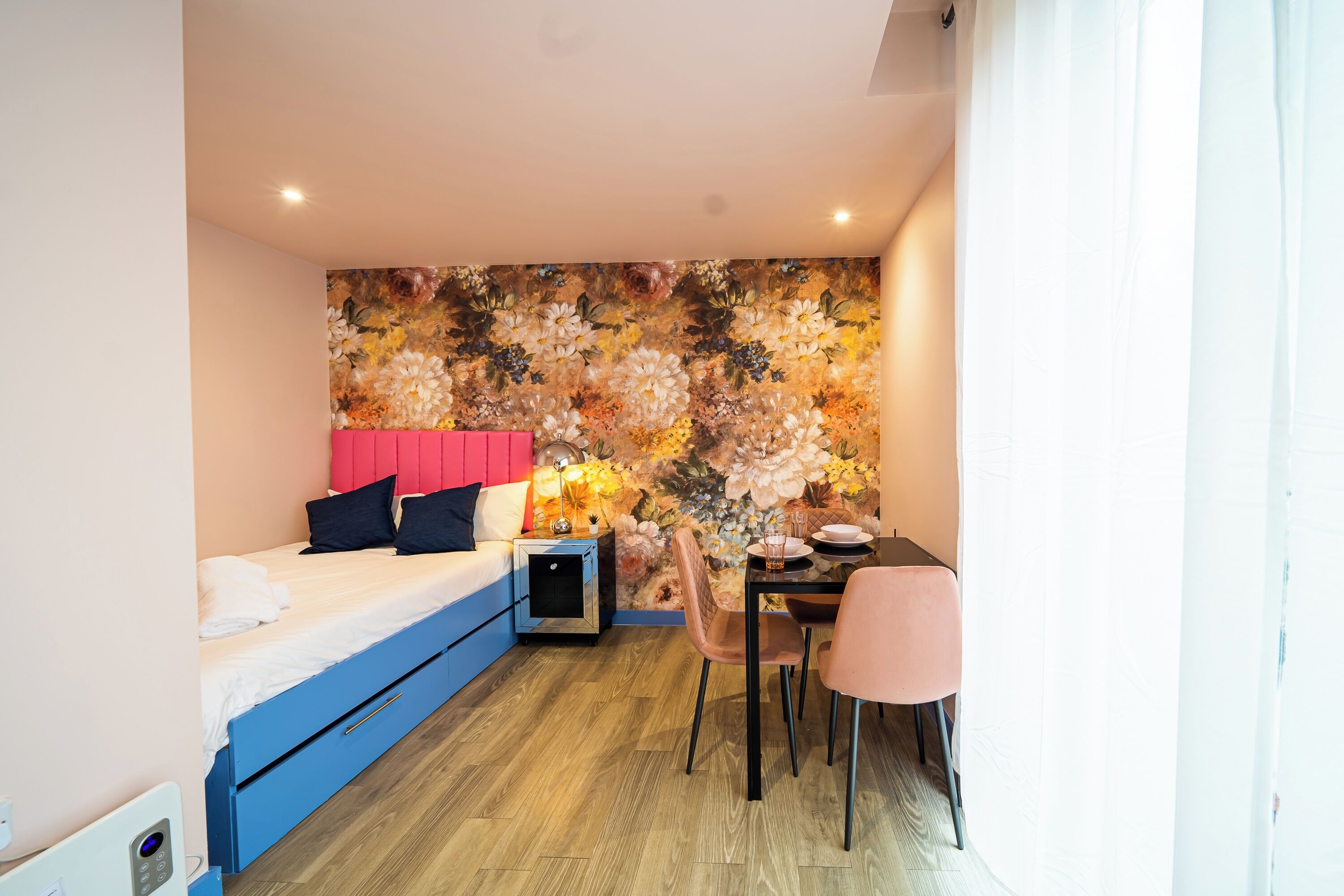 A compact room with a bed, a desk, and a chair.