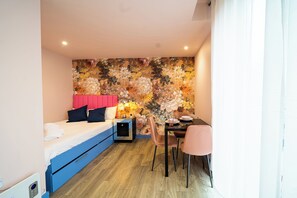 A compact room with a bed, a desk, and a chair. - Outstanding Deluxe Self Contained City Apartment (Sheffield)