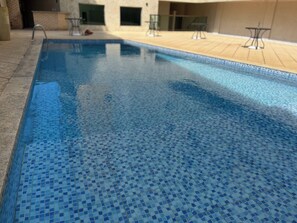 Ein Schwimmbecken mit gefliestem Boden und Beckenrand.