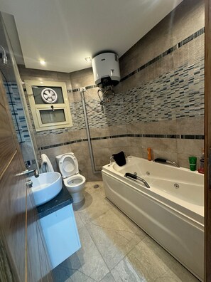 Shower, jetted bath, towels, soap