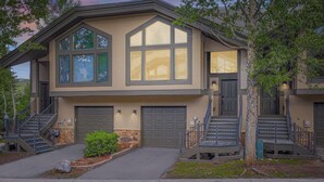 A two-story house with a garage, a staircase, and a small front yard.