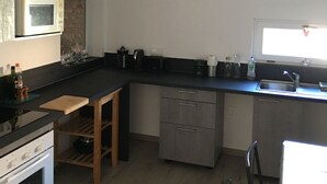A modern kitchen with a built-in oven, microwave, and dishwasher.