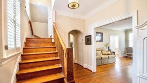 A wooden staircase leading to a living area with a sofa and a lamp. - Spacious & Private Augusta Getaway Near Downtown! (Augusta)