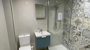 Shower, hair dryer, towels, toilet paper