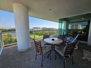 Enjoy a peaceful outdoor space with a round table and four chairs, offering a serene view of the surrounding green landscape.
