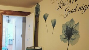 A bedroom with a wall decoration that reads "ALWAYS Kiss Me Good Night" and a lamp on a bedside table. - Charming -Clean-4-bedroom house with AC and WiFi in wonderful Springfield (Springfield)