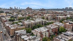 A dense urban area with a variety of building styles and a clear view of the skyline in the background.