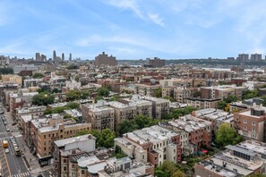 A dense urban area with a variety of building styles and a clear view of the skyline in the background.
