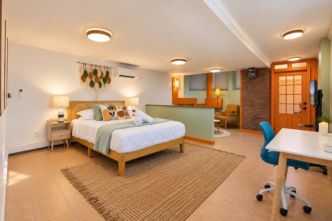 Een moderne slaapkamer met een bed, nachtkastjes, een bureau en een stoel.