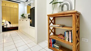 A modern living room with a wooden bookshelf, a sofa, and a dining area. - Jetsetter's Retreat (Carolina)