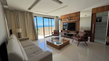 Luxury Apartment, Beach View | Living area | Flat-screen TV