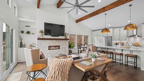 A modern kitchen with white cabinets, a central island, and pendant lighting.