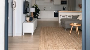 A modern apartment with a kitchen, living area, and a dining space.