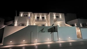 A modern building with a symmetrical facade, multiple balconies, and a central staircase. - Aristotle Suites, Aegle
 (Adamantas)