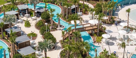 A resort with multiple swimming pools, palm trees, and sun loungers.