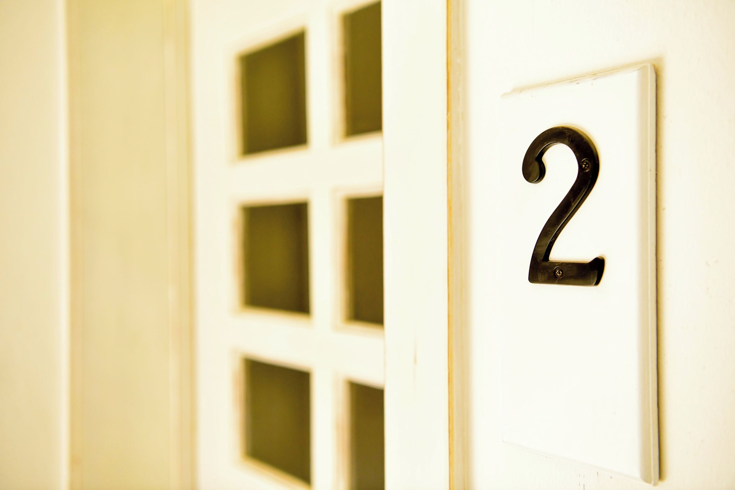 A door with a number 2 sign, indicating a room number.