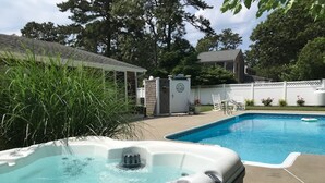 A backyard with a swimming pool and a hot tub. - New Eastham Oceanside Guest Suite with Pool and Hot Tub (Eastham)