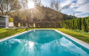 Relax by the serene pool surrounded by lush greenery and beautifully manicured lawns.