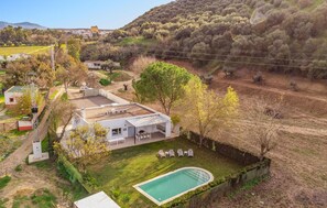 Enjoy a retreat with a swimming pool and patio area in a serene countryside setting.