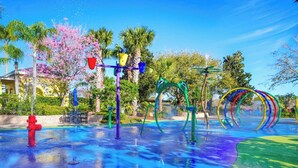 A water park with colorful play structures, a red fire hydrant, and palm trees. - Go!#12 - BAHAMA BAY - Three Bedroom Resort, Sleeps 6 (Davenport)