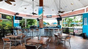 A restaurant with outdoor seating, ceiling fans, and a view of the beach. - Go!#12 - BAHAMA BAY - Three Bedroom Resort, Sleeps 6 (Davenport)