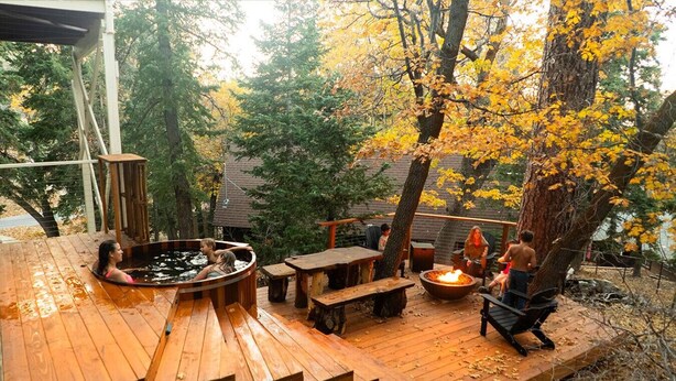 A wooden deck with a hot tub, a fire pit, and outdoor seating. - Walk to Bear Mountain-Rustic 3bd sleeps 9 Hot Tub and Fire Pit~0.2 Miles to Bear Mountain (Big Bear Lake)