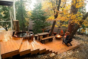 A wooden deck with a hot tub, a fire pit, and outdoor seating. - Walk to Bear Mountain-Rustic 3bd sleeps 9 Hot Tub and Fire Pit~0.2 Miles to Bear Mountain (Big Bear Lake)