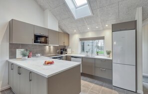 Fridge, stovetop, dishwasher, coffee/tea maker